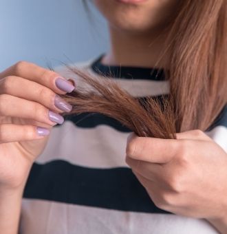 Woman Holding Damaged Hair