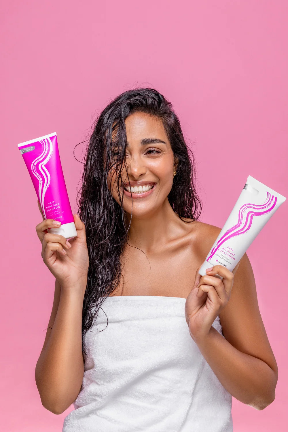 Model Holding Deep Moisture Shampoo And Conditioner Bottles